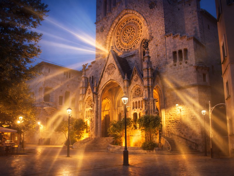 Sant Bartomeu church in Soller Mallorca with historic tram in the Tramuntana mountains